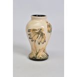 A MODERN MOORCROFT POTTERY SMALL BALUSTER VASE, decorated in a cornflower pattern, impressed,
