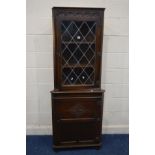 A JAYCEE OAK LEAD GLAZED CORNER CUPBOARD (no key)