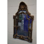 A MODERN FOLIATE GILT RESIN WALL MIRROR, 64cm x 110cm