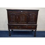 AN 18TH CENTURY AND LATER CARVED OAK TWO DOOR DEUDDARN, carved triple panel front, above two drawers
