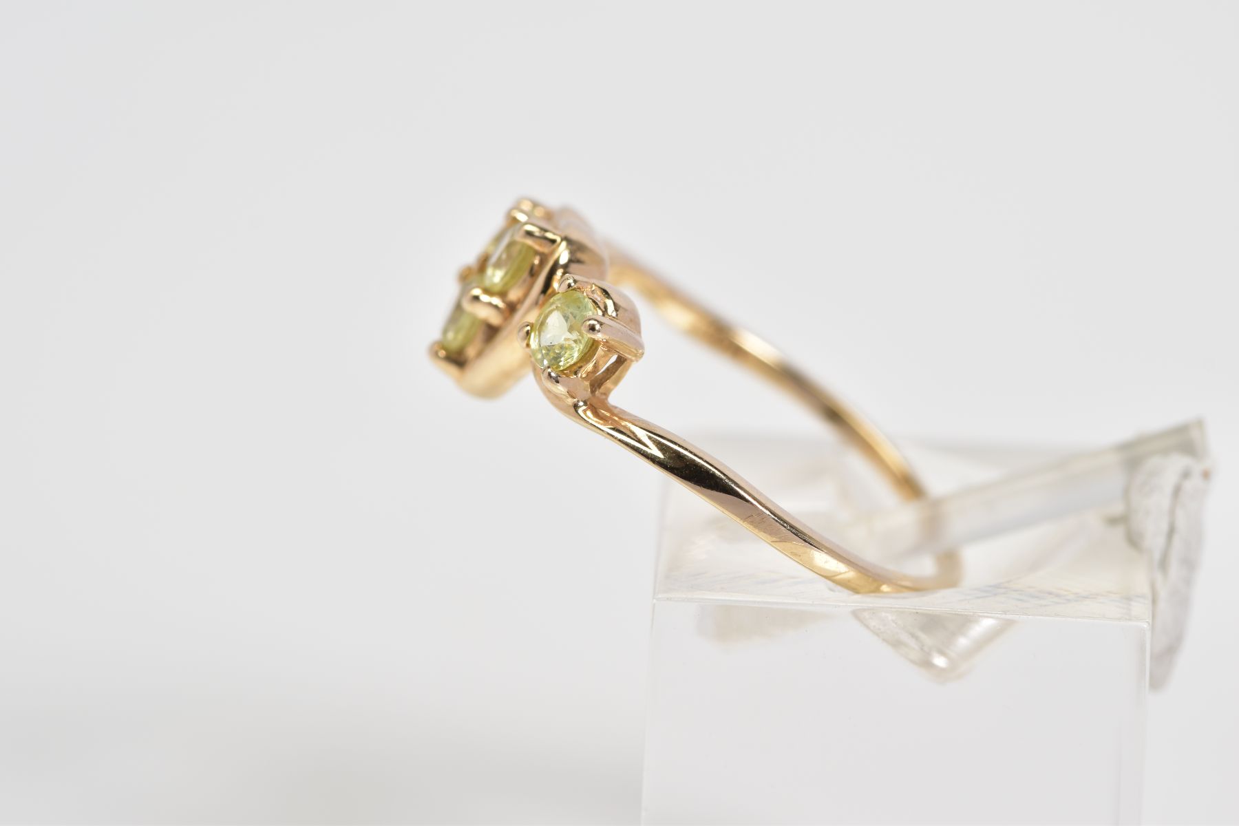 A 9CT GOLD RING, designed with a central heart panel set with three circular cut stones assessed - Image 2 of 3