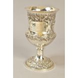 A VICTORIAN SILVER CUP, repousse decorated with a rural scene of two men and horses ploughing,