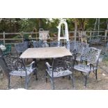 A LARGE STONE EFFECT GARDEN TABLE AND EIGHT CHAIRS, with real stone veneers in a crazy paving effect