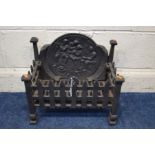 A CAST IRON FIRE GRATE, the back depicting a social gathering, width 44cm x depth 26cm x height