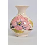 A MOORCROFT POTTERY SQUAT BALUSTER VASE, cream ground with pink magnolia, crazed, impressed and