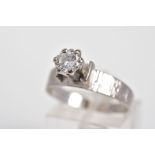 A SINGLE STONE DIAMOND RING, a claw set round brilliant cut diamond within a raised mount, total