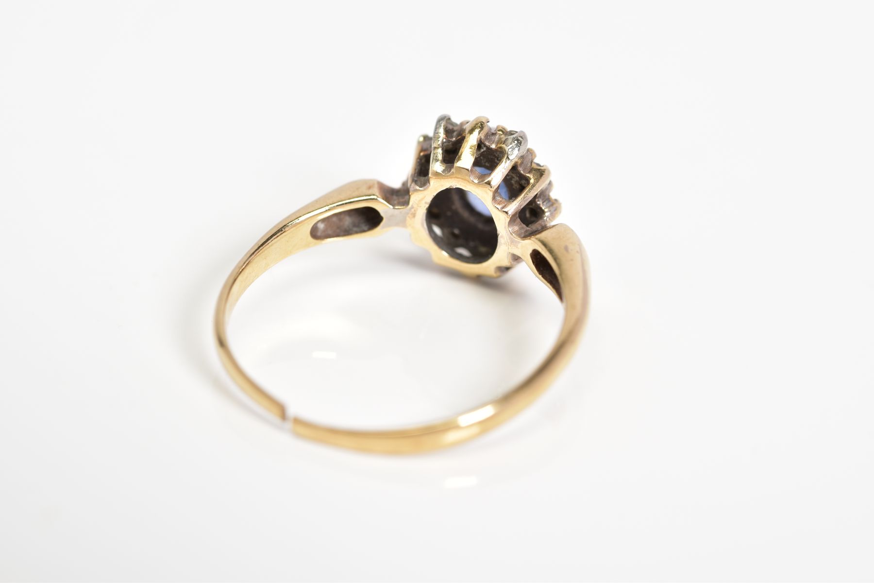 A 9CT GOLD CLUSTER RING, set with a central oval cut sapphire, single cut diamond surround to the - Image 3 of 3