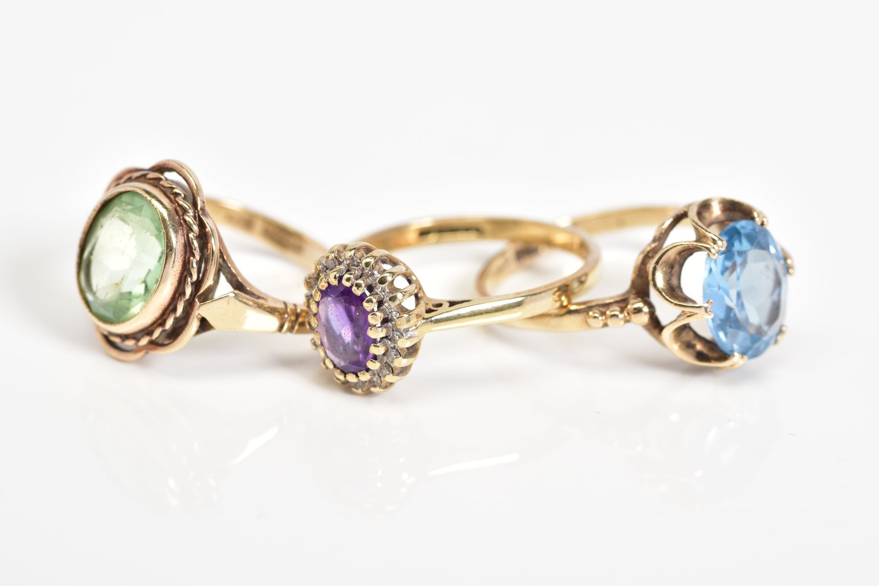 THREE 9CT GOLD GEM SET RINGS, to include an oval cut topaz within a scallop surround, with a 9ct - Image 2 of 3