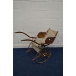 AN EARLY 20TH CENTURY BEECH CHILDS BENTWOOD RICKSHAW, having a fabric seat and footrest, on twin
