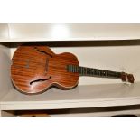 AN ARCH TOP JAZZ ACOUSTIC GUITAR, with laminated top containing holes, foating rosewood bridge,