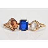 THREE 9CT GOLD GEM SET RINGS, to include an oval cut topaz within a four claw setting to the