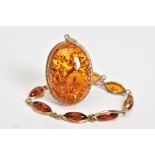 A 9CT GOLD AMBER BRACELET AND PENDANT, the bracelet designed with eight lozenge shape amber links,
