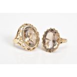 TWO 9CT GOLD SMOKEY QUARTZ RINGS, the first designed with a large oval cut smokey quartz, within a