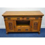 AN EARLY 20TH CENTURY GOLDEN OAK SIDEBOARD, with two long drawers above two foliate panelled