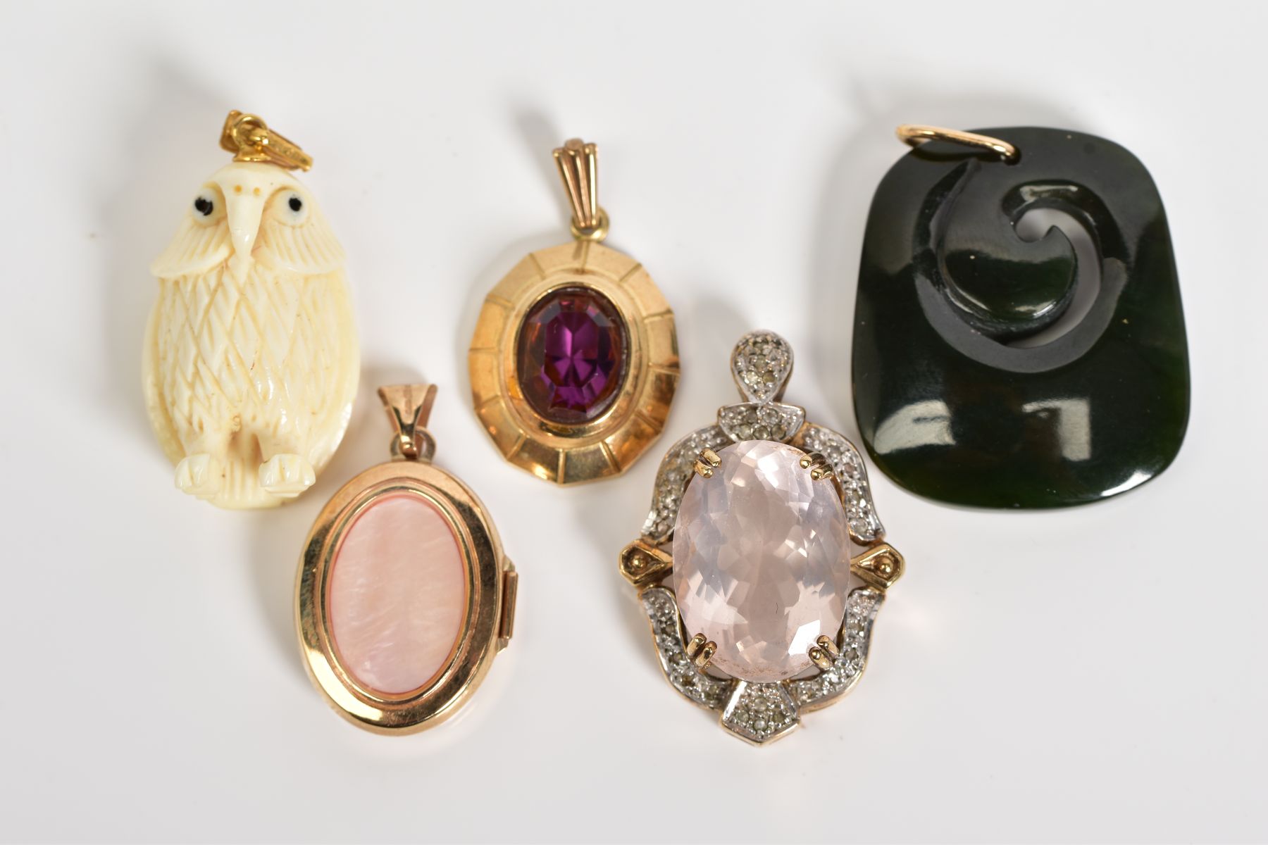 A SELECTION OF FIVE PENDANTS, to include a large oval cut rose quartz within a four claw setting and