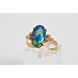 AN OPAL TRIPLET RING, the oval opal triplet set within a four claw setting, to the bead detail
