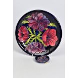 A MOORCROFT POTTERY PLATE, dark blue ground with pink/purple anenomes, impressed and painted