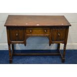 A REPRODUCTION OAK DESK, with two deep linenfold front drawers flanking a single drawer, on turned