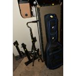 A RECTANGULAR HARD CASE FOR AN ELECTRIC GUITAR, a soft guitar case, four guitar stands and a folding