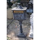 A MODERN CAST IRON POST BOX, with Chinese pagoda style roof, horse and rider detail to casting on