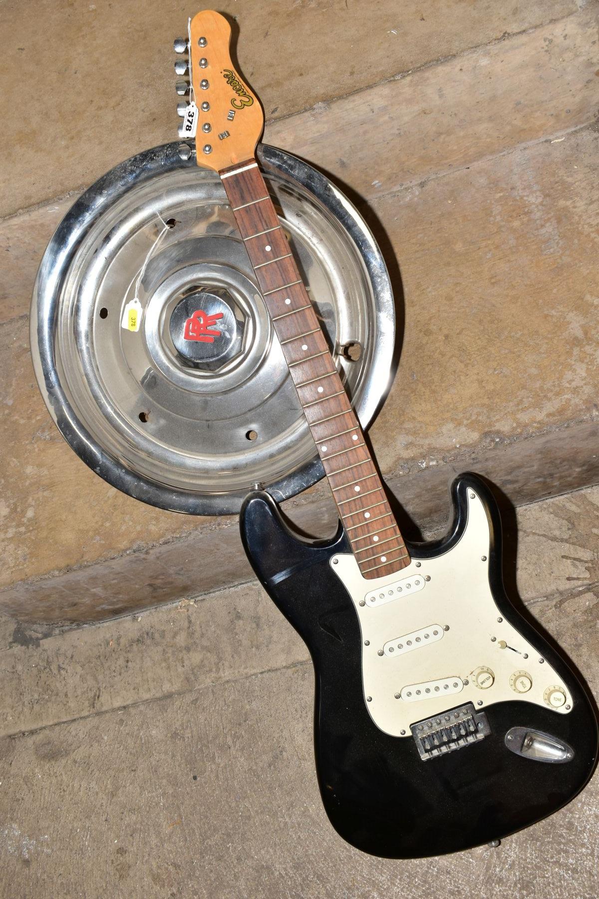 A ROLLS ROYCE HUB CAP AND AN ENCORE STRAT TYPE GUITAR, in black with white scratch plate, three