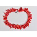 A CORAL BRANCH NECKLACE, with forty five tapered dyed red coral branch beads, each measuring