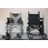 TWO WHEELCHAIRS, both with footrests, one is a Enigma with a silver finish and a standard 4cm wide