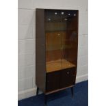 A TALL 1950'S TEAK DOUBLE GLAZED SLIDING DOOR BOOKCASE, with two glass shelves and double sliding