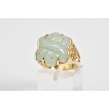 A 14CT GOLD JADE RING, a carved jade panel set within a four claw setting, with Oriental design open