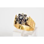 AN 18CT GOLD SAPPHIRE AND DIAMOND CLUSTER RING, the tiered cluster set with a central circular cut