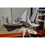A WOODEN MODEL OF A FISHING BOAT, a display case of knots, a wooden fish and waves hanging