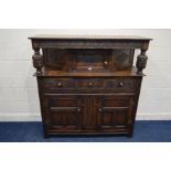 AN EARLY TO MID 20TH CENTURY CARVED OAK COURT CUPBOARD, the overhanging top flanking with acorn