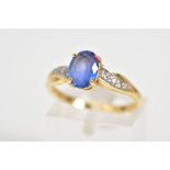 AN 18CT GOLD SAPPHIRE AND DIAMOND RING, designed with a central oval cut sapphire with round