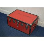 A VINTAGE RED GROUND TRAVELLING TRUNK, and a circular tin (2)