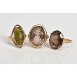 THREE 9CT GOLD GEM SET RINGS, the first designed with a large oval cut smokey quartz, within a