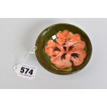 A MOORCROFT POTTERY SMALL TRINKET BOWL, low circular foot, green ground with coral hibiscus,