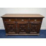 AN EARLY 20TH CENTURY OAK SIDEBOARD, with three drawers, above three geometric panelled doors, width