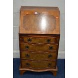 A SLIM REPRODUCTION YEW WOOD SERPENTINE FALL FRONT BUREAU, four drawers on bracket feet, width