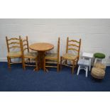 A MODERN PINE CIRCULAR KITCHEN TABLE, and four rush seated ladder back chairs (one chair with s.d.),