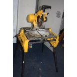 A DEWALT DW743 FLIP OVER SAW, 110 volt with four detachable legs (untested due to voltage)