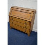 A MID 20TH CENTURY GOLDEN OAK FALL FRONT BUREAU, with a fitted interior above three drawers, width