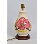 A MOORCROFT POTTERY BALUSTER TABLE LAMP, cream ground with pink magnolia design, mounted on a wooden
