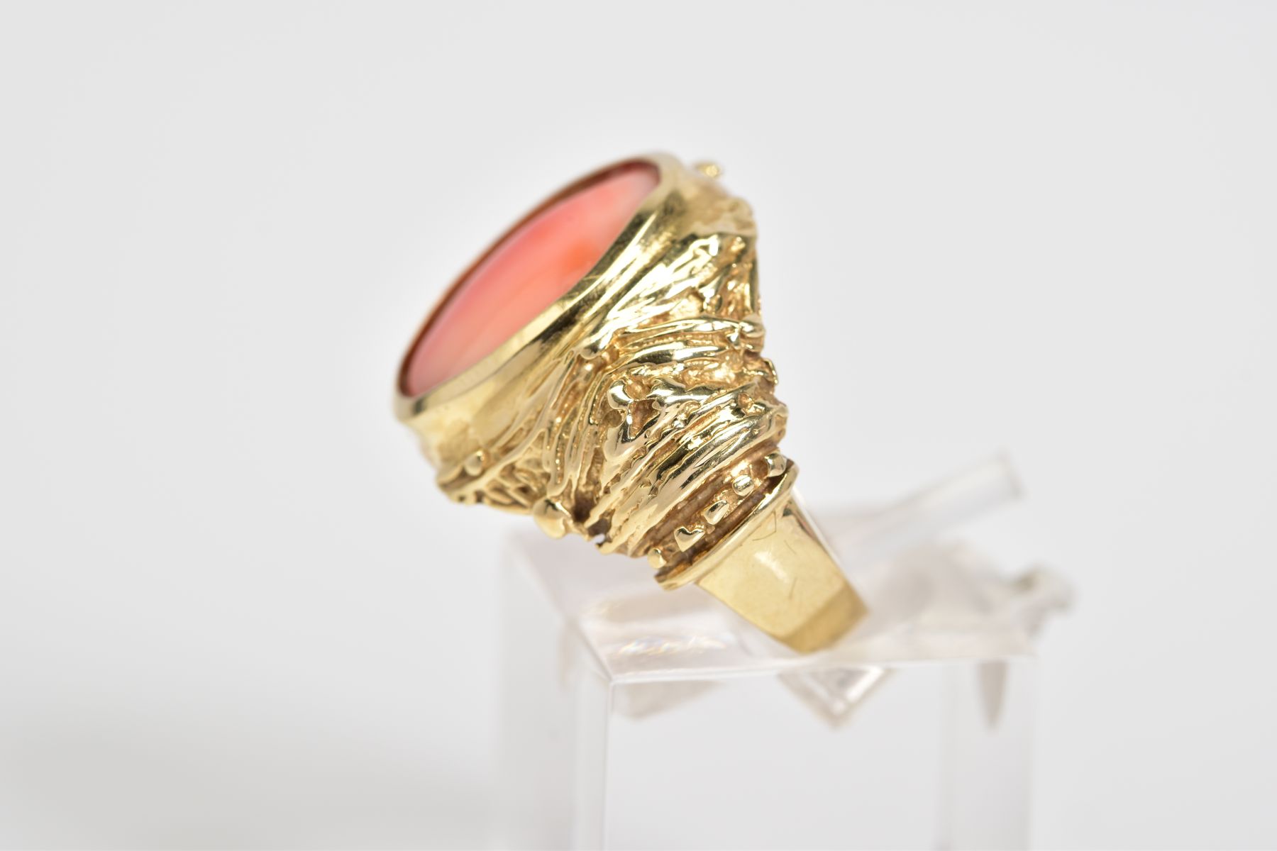 A CORAL SET RING, the yellow metal ring designed with a central oval coral panel within a collet - Image 2 of 4