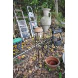 TWO COMPOSITE GARDEN EWERS ON IRON STANDS, one standing approximate 151mm from floor to top, the