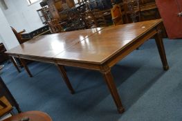 AN EARLY 20TH CENTURY OAK BOARDROOM TABLE, the top, frieze and legs solid oak, the centre table with