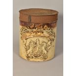 A VICTORIAN STONEWARE CYLINDRICAL JAR WITH TIN COVER, worn gilt lettering and applied Royal crest,