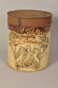 A VICTORIAN STONEWARE CYLINDRICAL JAR WITH TIN COVER, worn gilt lettering and applied Royal crest,