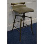 A VINTAGE INDUSTRIAL BRASS SWIVEL STOOL on a tubular base