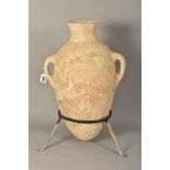 AN ANCIENT ROMAN TWIN HANDLED AMPHORA, in a wrought iron stand, height 50cm, with a certificate of