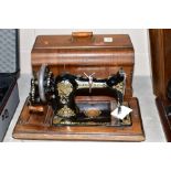 AN EARLY 20TH CENTURY JONES 'FAMILY C.S' HAND SEWING MACHINE, gilt and red transfer decoration, with